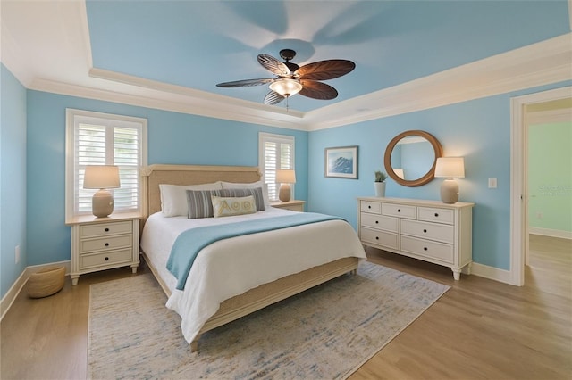 5033 Cabrilla Ct, New Port Richey, FL 34652 - bedroom featuring a tray ceiling, wood finished floors, crown molding, and multiple windows