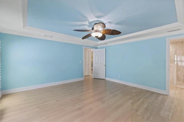5033 Cabrilla Ct, New Port Richey, FL 34652 - unfurnished room with a tray ceiling, ceiling fan, light wood-type flooring, and ornamental molding