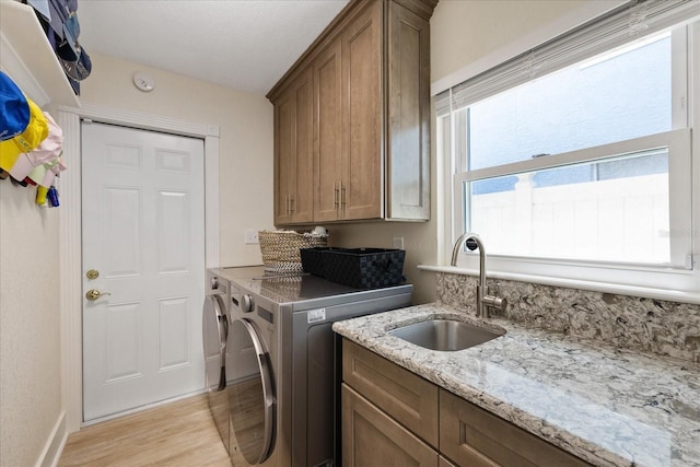 5033 Cabrilla Ct, New Port Richey, FL 34652 - laundry area with cabinet space, separate washer and dryer, and light wood-style flooring