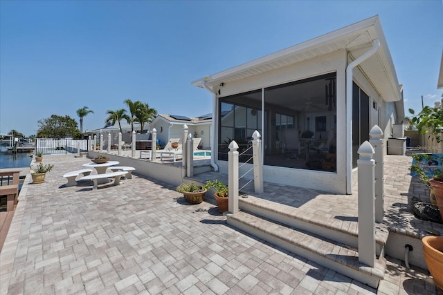 5033 Cabrilla Ct, New Port Richey, FL 34652 - view of patio featuring a sunroom and a swimming pool