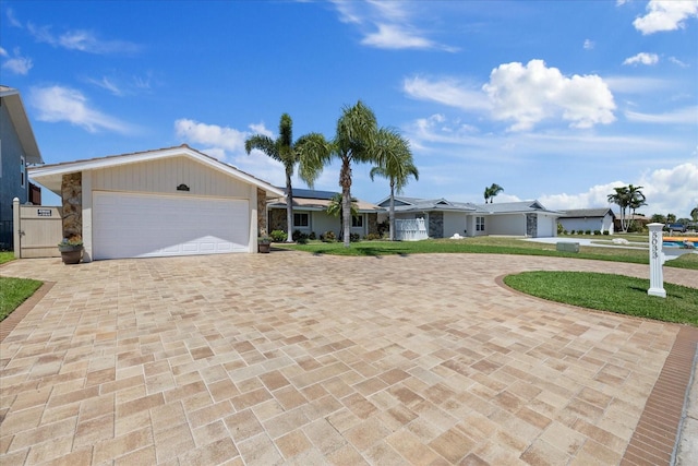 5033 Cabrilla Ct, New Port Richey, FL 34652 - ranch-style home with decorative driveway, an attached garage, solar panels, and a front lawn