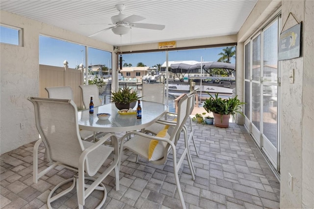 5033 Cabrilla Ct, New Port Richey, FL 34652 - sunroom / solarium with ceiling fan, brick flooring, outdoor dining area, and a textured wall
