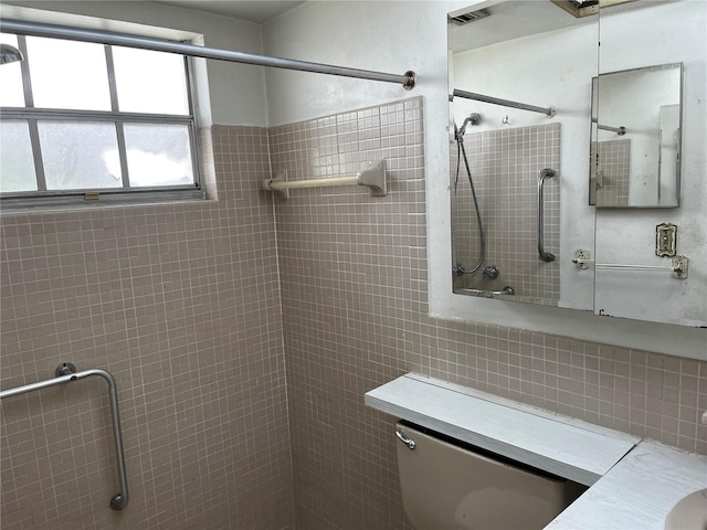 full bathroom featuring tile walls and tiled shower