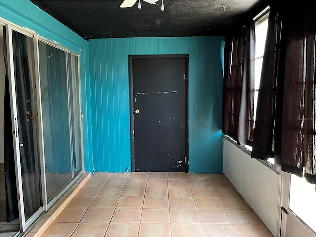 interior space with ceiling fan