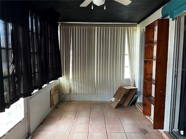 unfurnished sunroom with a wealth of natural light and a ceiling fan