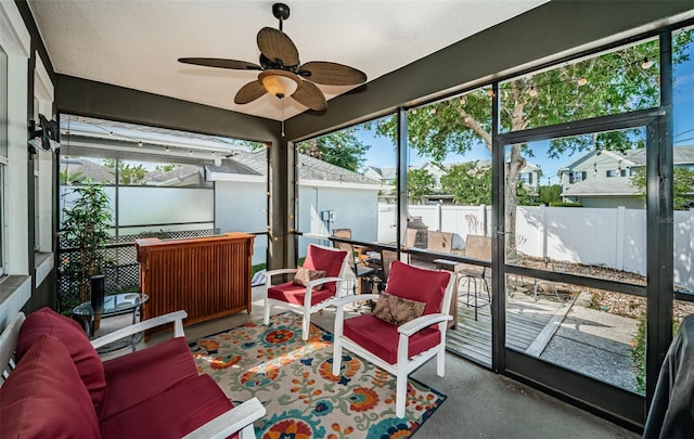 sunroom with a ceiling fan