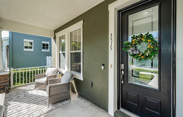 property entrance featuring stucco siding and a porch