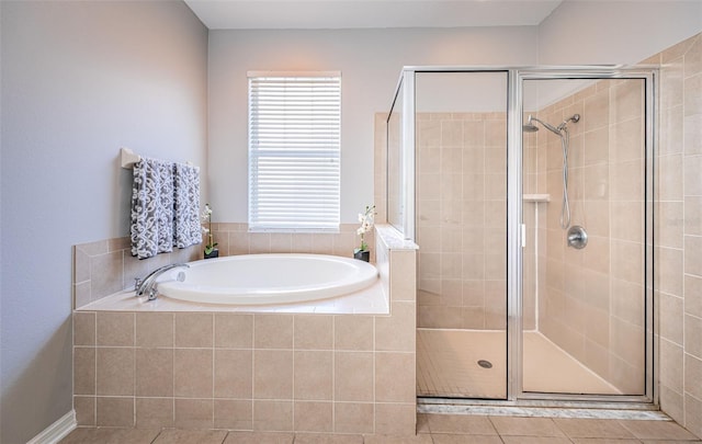 bathroom featuring tile patterned floors, a shower stall, and a bath
