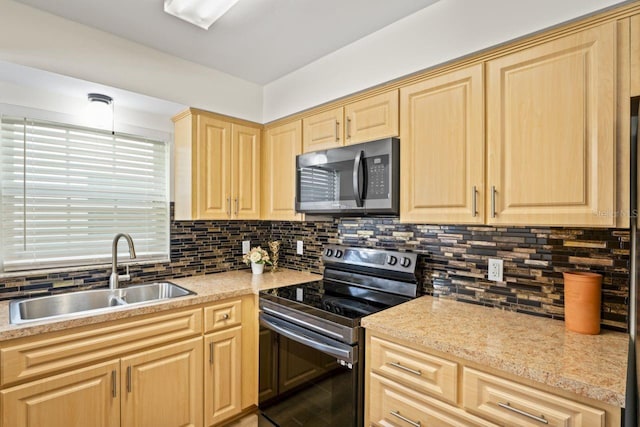 kitchen featuring a sink, backsplash, light brown cabinets, and stainless steel appliances