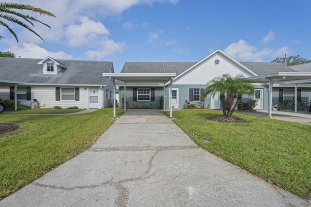 view of front of house with a carport, driveway, and a front lawn