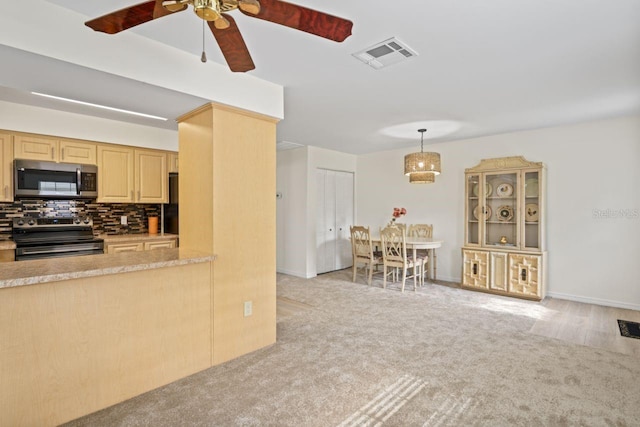 kitchen with visible vents, decorative backsplash, light brown cabinets, ceiling fan, and appliances with stainless steel finishes