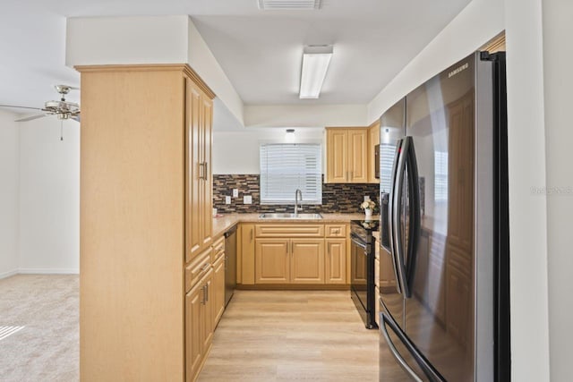 kitchen featuring a sink, light brown cabinetry, stainless steel dishwasher, and refrigerator with ice dispenser