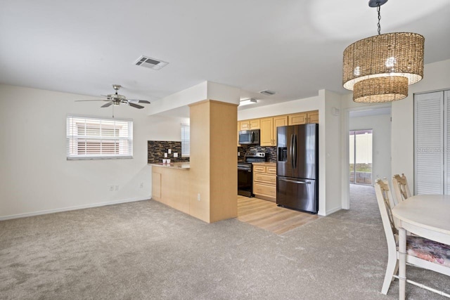 kitchen with electric range, visible vents, fridge with ice dispenser, stainless steel microwave, and light carpet