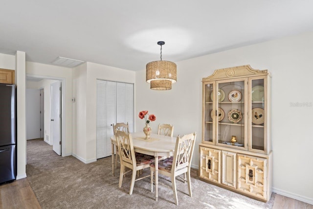 dining room featuring baseboards and wood finished floors