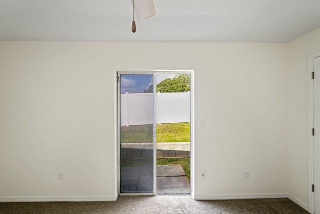 spare room with baseboards and carpet