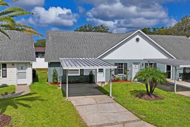 view of front of property featuring roof with shingles, a carport, a front lawn, and brick siding