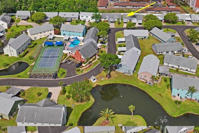 drone / aerial view with a water view and a residential view