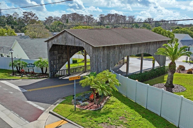view of home's community with fence and a yard