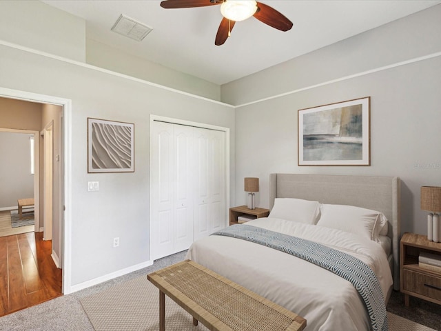 10318 Piper Dr, New Port Richey, FL 34654 - bedroom featuring carpet floors, a closet, baseboards, visible vents, and a ceiling fan