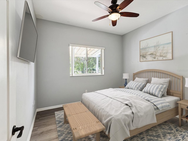 10318 Piper Dr, New Port Richey, FL 34654 - bedroom featuring baseboards, wood finished floors, and a ceiling fan