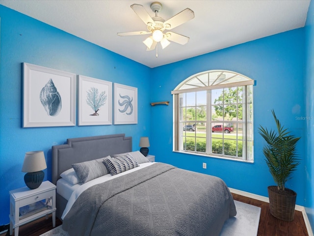 10318 Piper Dr, New Port Richey, FL 34654 - bedroom featuring wood finished floors, ceiling fan, and baseboards