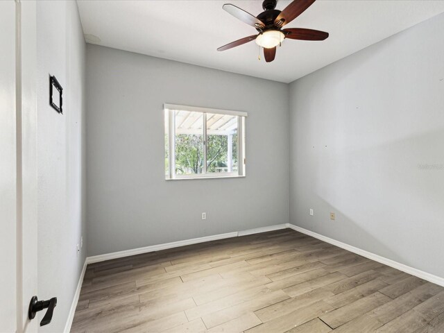 10318 Piper Dr, New Port Richey, FL 34654 - empty room with baseboards, wood finished floors, and a ceiling fan