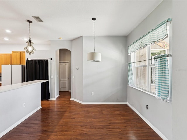 10318 Piper Dr, New Port Richey, FL 34654 - unfurnished dining area featuring recessed lighting, visible vents, baseboards, arched walkways, and dark wood finished floors