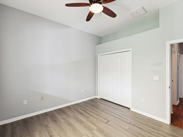 10318 Piper Dr, New Port Richey, FL 34654 - unfurnished bedroom with a closet, visible vents, wood finished floors, and baseboards