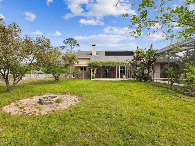 10318 Piper Dr, New Port Richey, FL 34654 - rear view of property featuring a patio area, an outdoor fire pit, a yard, a chimney, and fence
