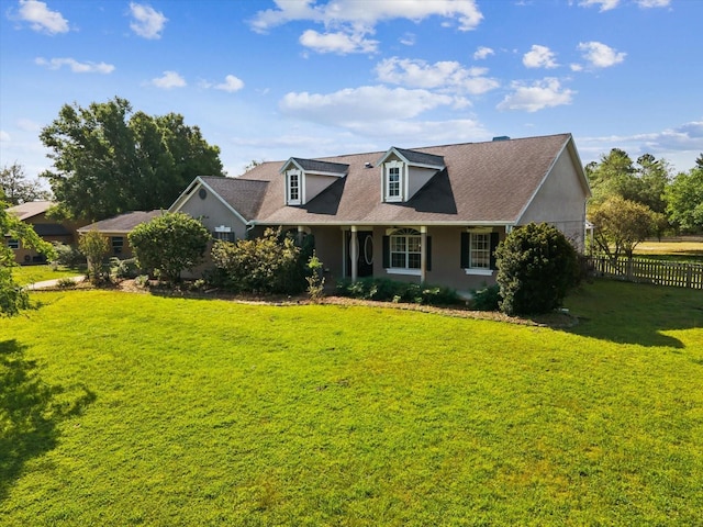 10318 Piper Dr, New Port Richey, FL 34654 - cape cod-style house featuring a front yard, a shingled roof, and fence