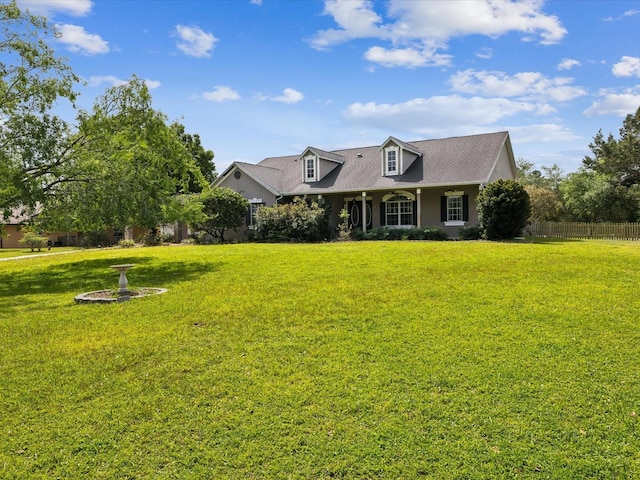 10318 Piper Dr, New Port Richey, FL 34654 - cape cod-style house featuring a front lawn, roof with shingles, and fence