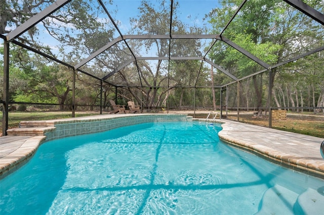 outdoor pool with a patio area and glass enclosure