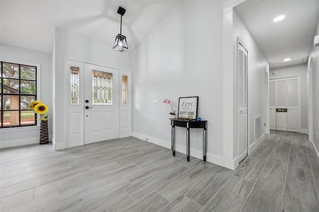 entrance foyer with visible vents, baseboards, and light wood finished floors