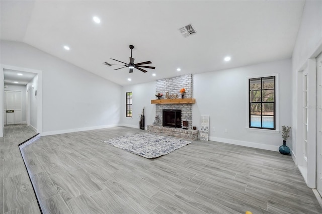unfurnished living room with a fireplace, a ceiling fan, visible vents, recessed lighting, and baseboards