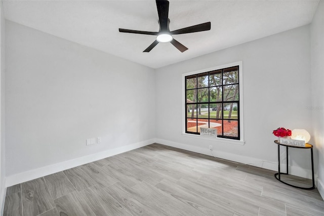 spare room with baseboards and ceiling fan