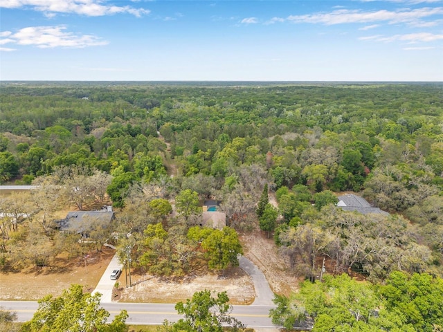 birds eye view of property featuring a view of trees