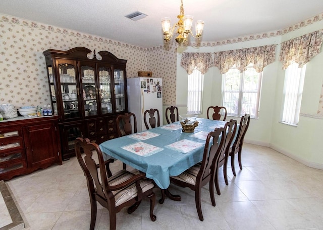 dining area with visible vents, wallpapered walls, a chandelier, and light tile patterned flooring