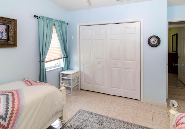 bedroom with a closet and light tile patterned flooring