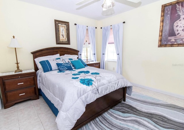 bedroom with light tile patterned flooring, baseboards, and a ceiling fan