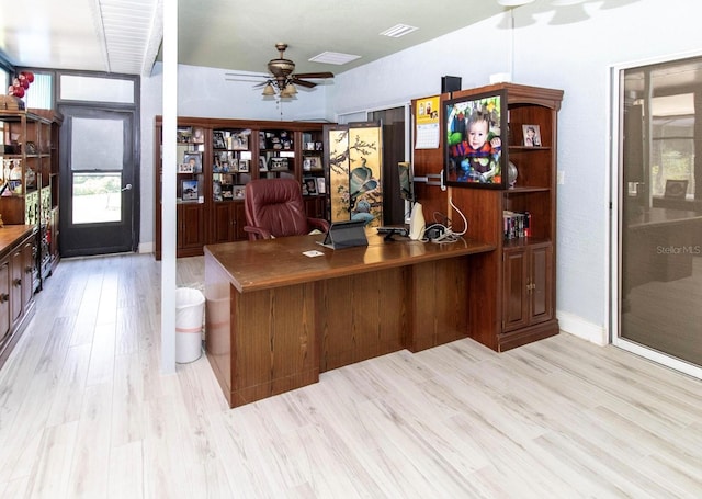 home office with light wood finished floors, a ceiling fan, and visible vents