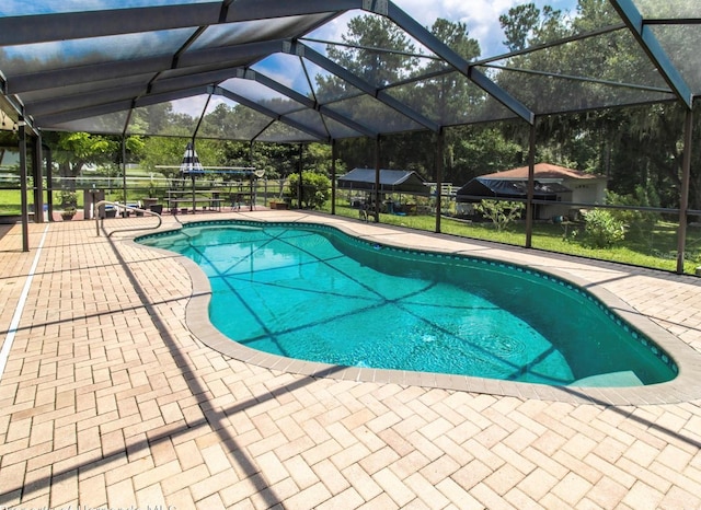 outdoor pool featuring a patio area and a lanai