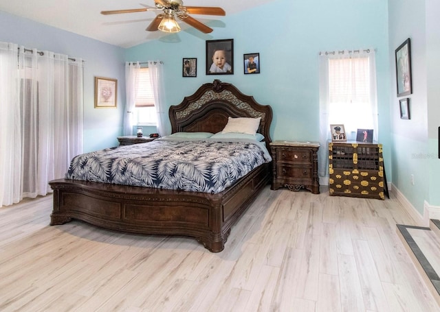 bedroom with wood finished floors, a ceiling fan, and lofted ceiling