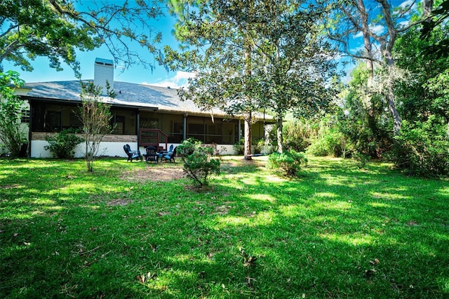 view of yard with a sunroom