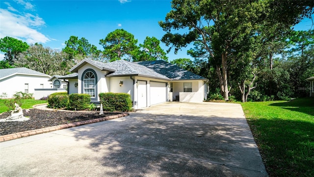 single story home featuring concrete driveway, an attached garage, a front lawn, and stucco siding