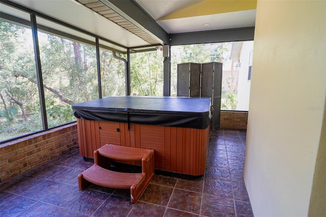 sunroom with a jacuzzi and a wealth of natural light