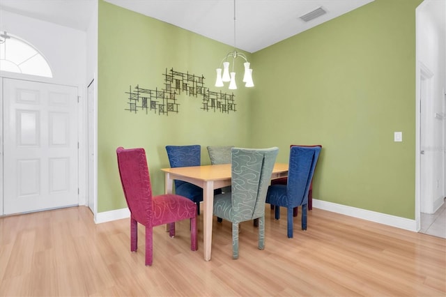 6109 Japonica Ct, New Port Richey, FL 34655 - dining space featuring visible vents, baseboards, an inviting chandelier, and wood finished floors