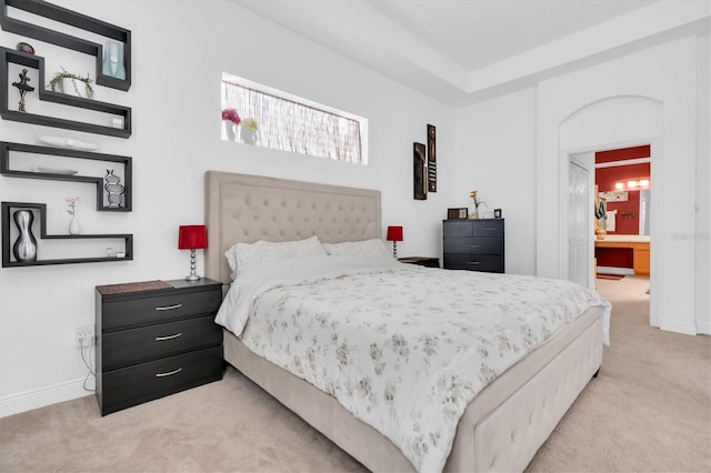 6109 Japonica Ct, New Port Richey, FL 34655 - bedroom featuring light colored carpet, baseboards, and ensuite bathroom