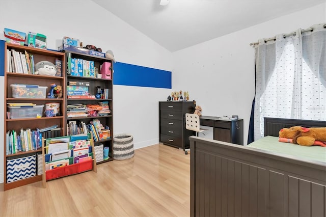 6109 Japonica Ct, New Port Richey, FL 34655 - bedroom featuring light wood finished floors, baseboards, and lofted ceiling