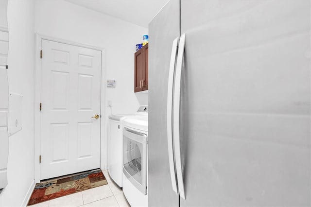 6109 Japonica Ct, New Port Richey, FL 34655 - clothes washing area featuring cabinet space, light tile patterned floors, and independent washer and dryer