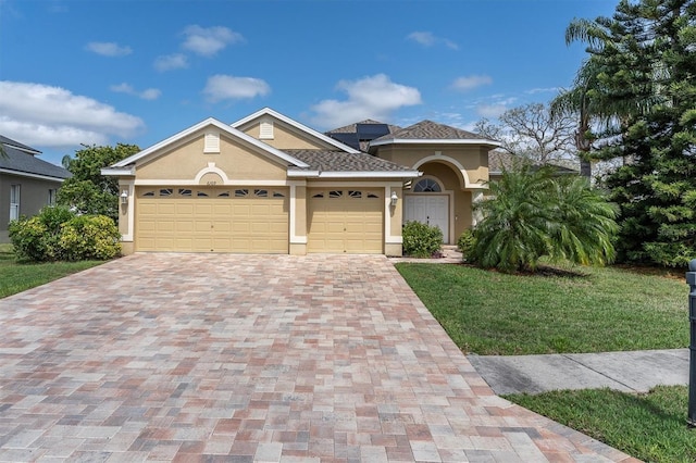 6109 Japonica Ct, New Port Richey, FL 34655 - mediterranean / spanish house with a garage, stucco siding, a front yard, and decorative driveway